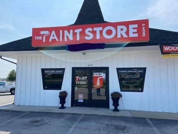 Paint store sign uses a paint roller in place of the P and from a distance it looks like an inappropriate word instead of paint.